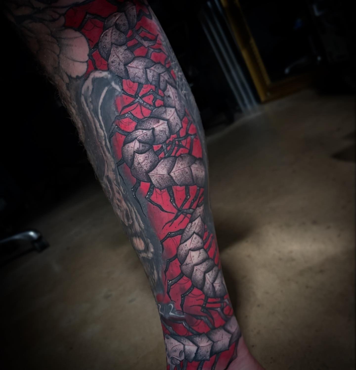 Cracked-stone geometric leg sleeve with a red underglow