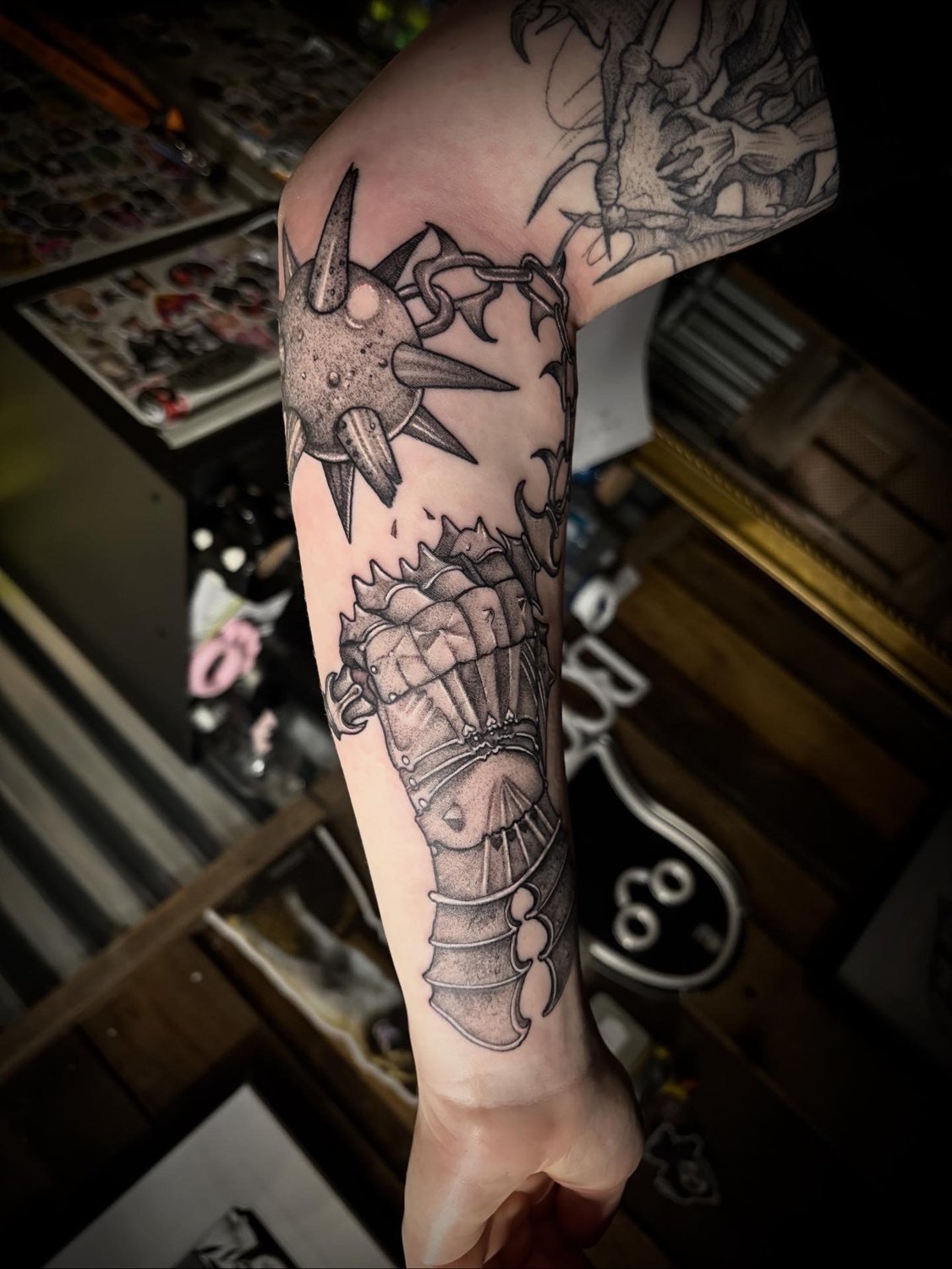 Medieval spiked flail and armoured gauntlet in blackwork