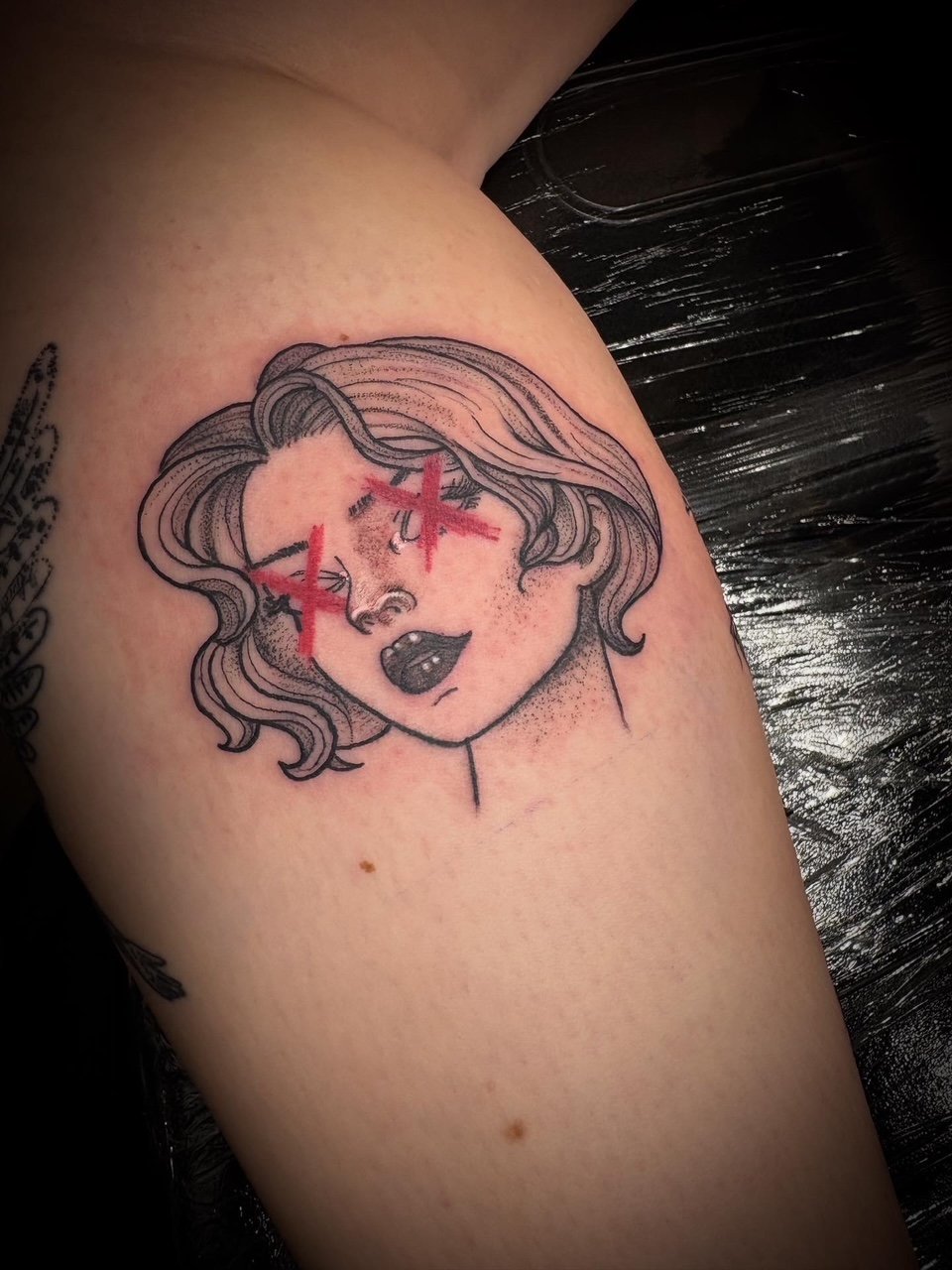 Fine-line portrait of a woman with red cross eyes