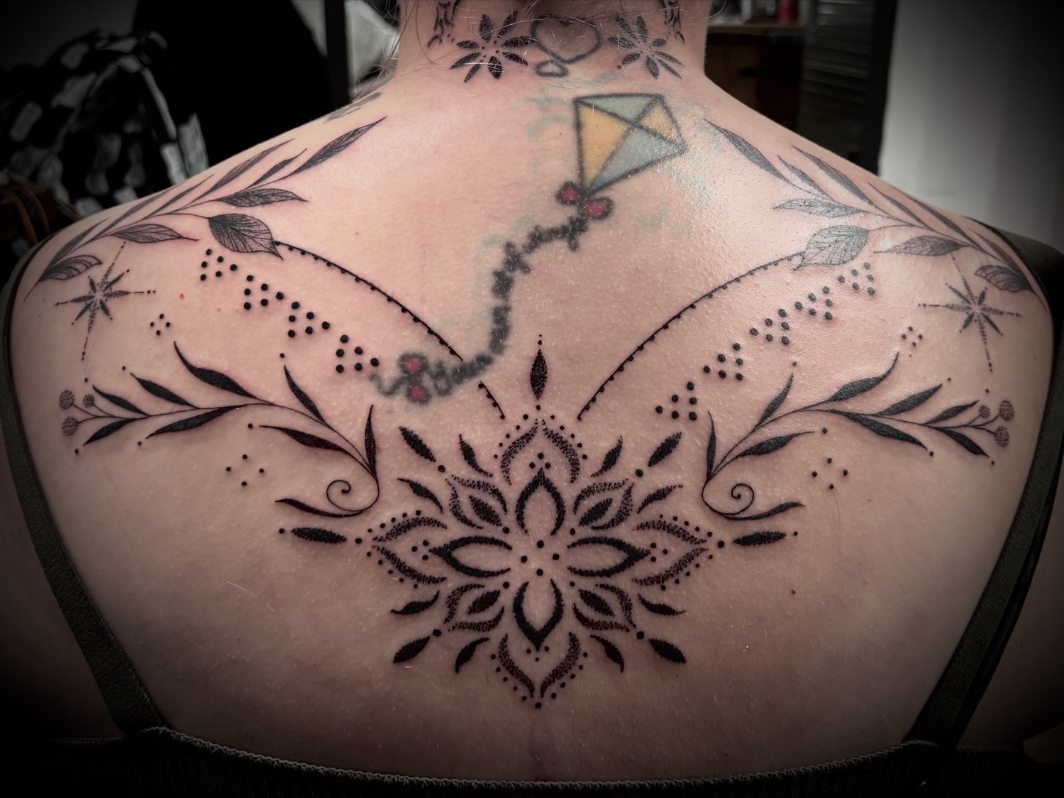 Symmetrical ornamental upper-back piece in fine dotwork